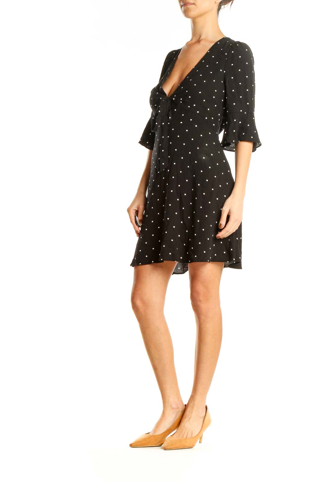 Front view of Free People black polka dot mini dress with V-neck and tie detail