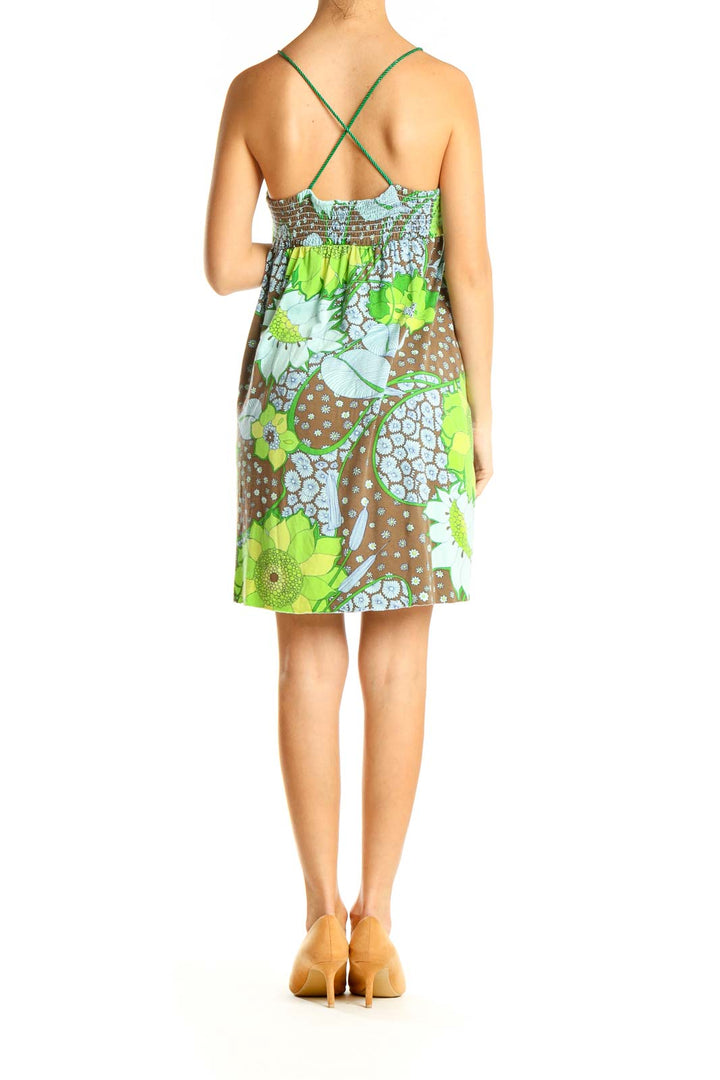 Back view of Free People green floral sundress showing criss-cross straps