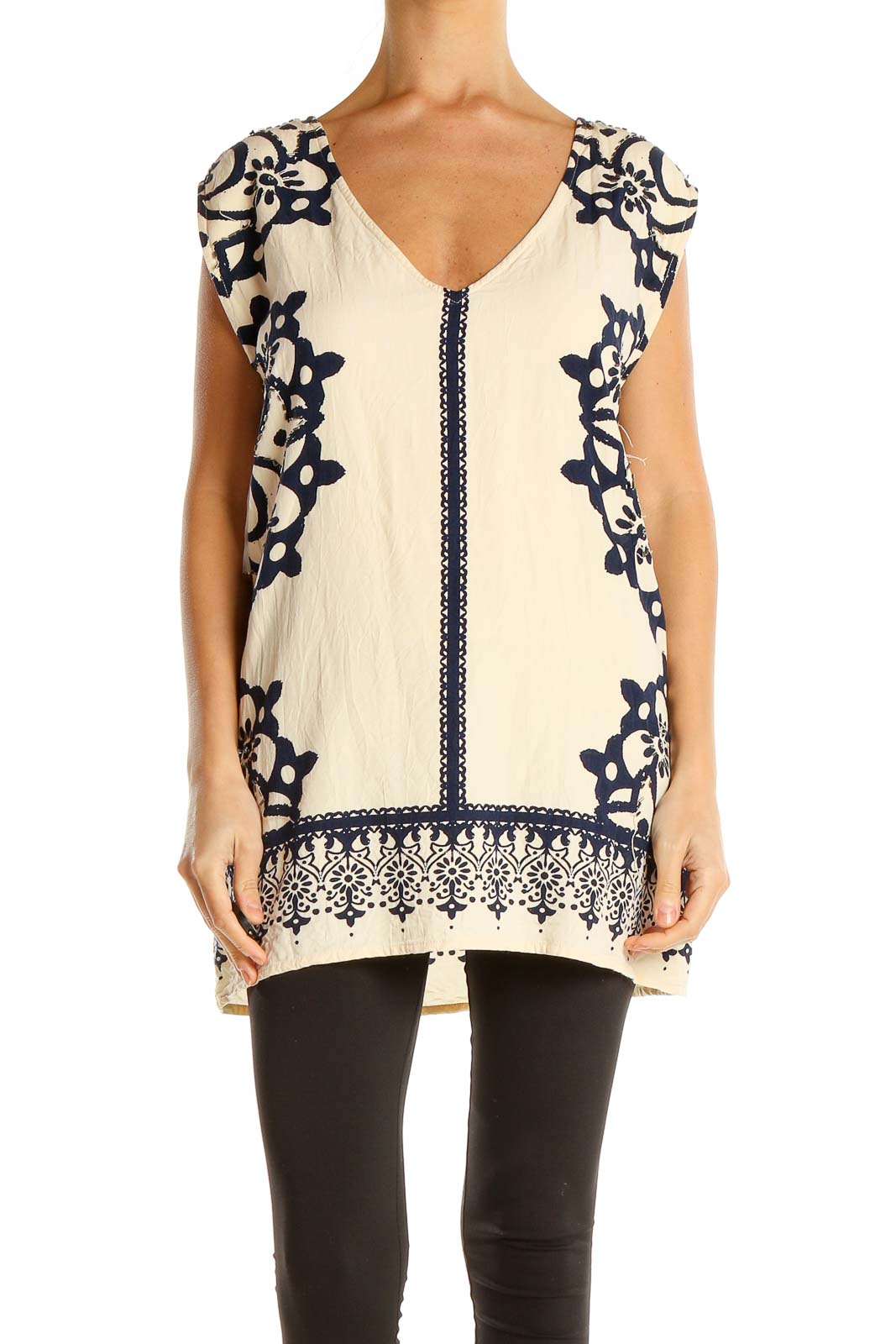 Front view of cream Free People tunic top with navy embroidery