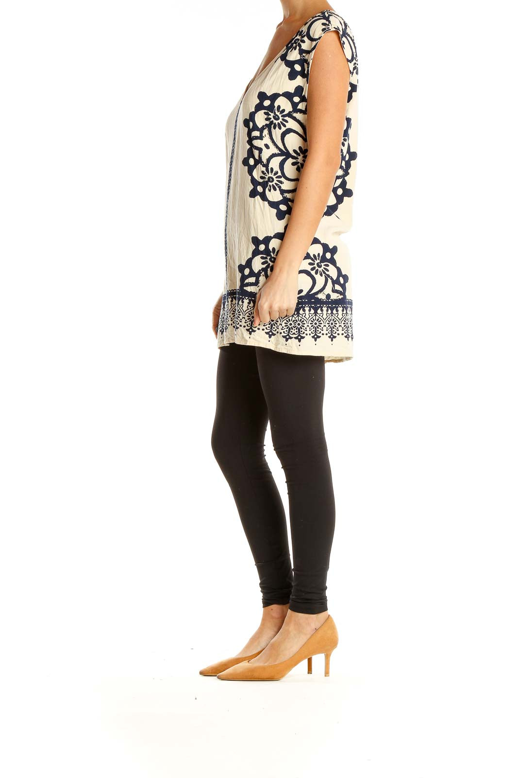 Front view of cream Free People tunic top with navy embroidery