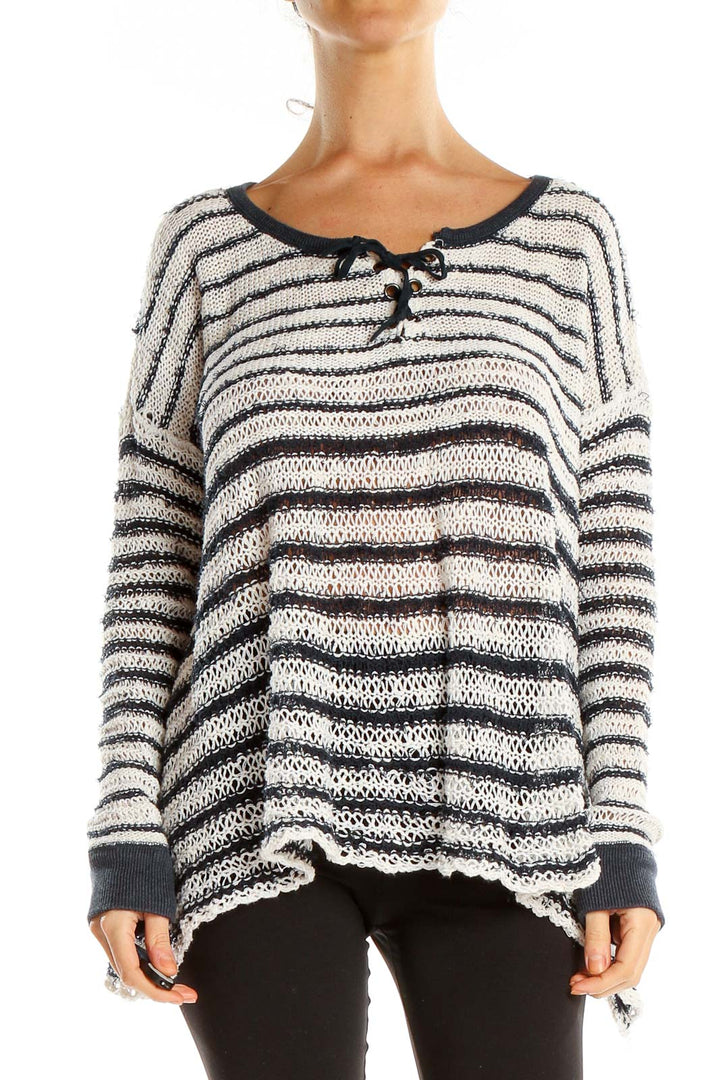 Front view of Free People white and black striped oversized knit sweater with toggle closures