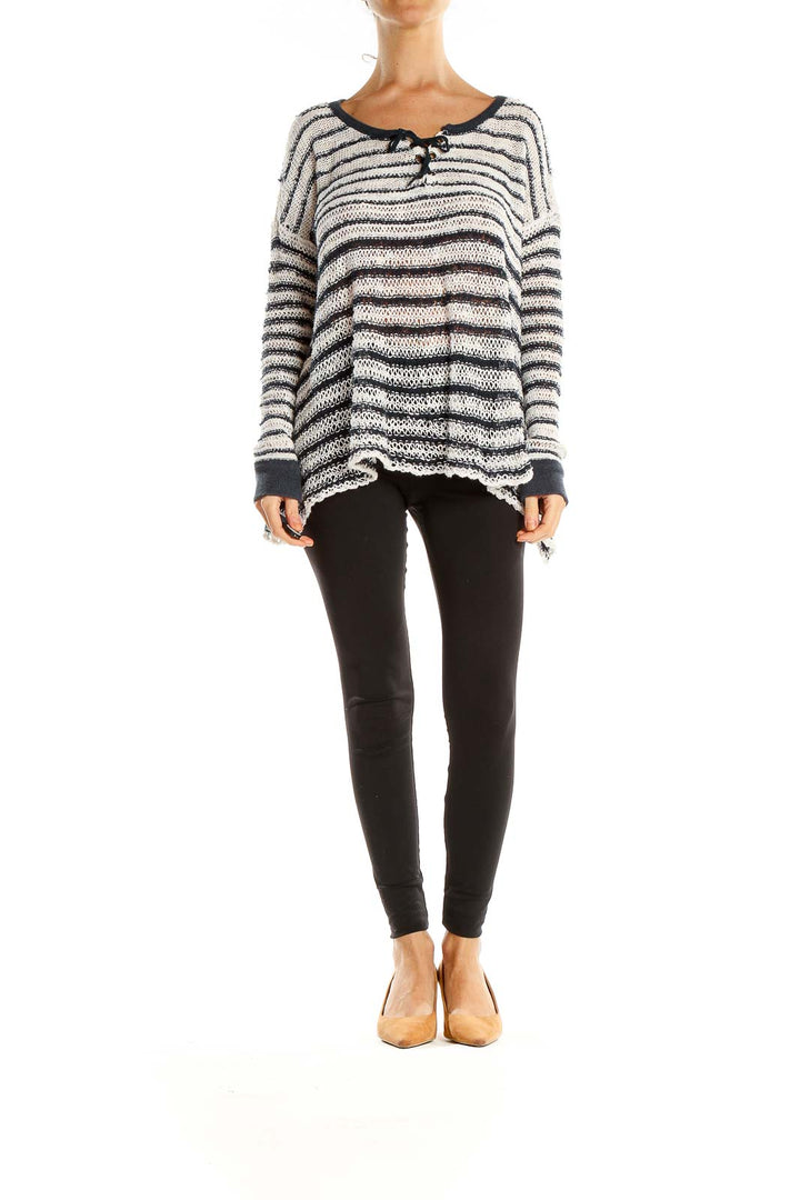 Front view of Free People white and black striped oversized knit sweater with toggle closures