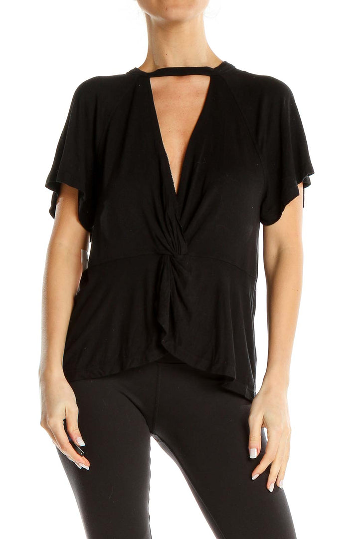 Front view of black Free People top with twist-front design and cutout detail