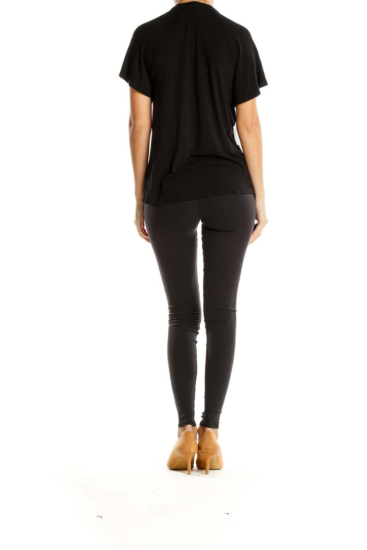 Back view of black Free People top showing relaxed fit and short sleeves