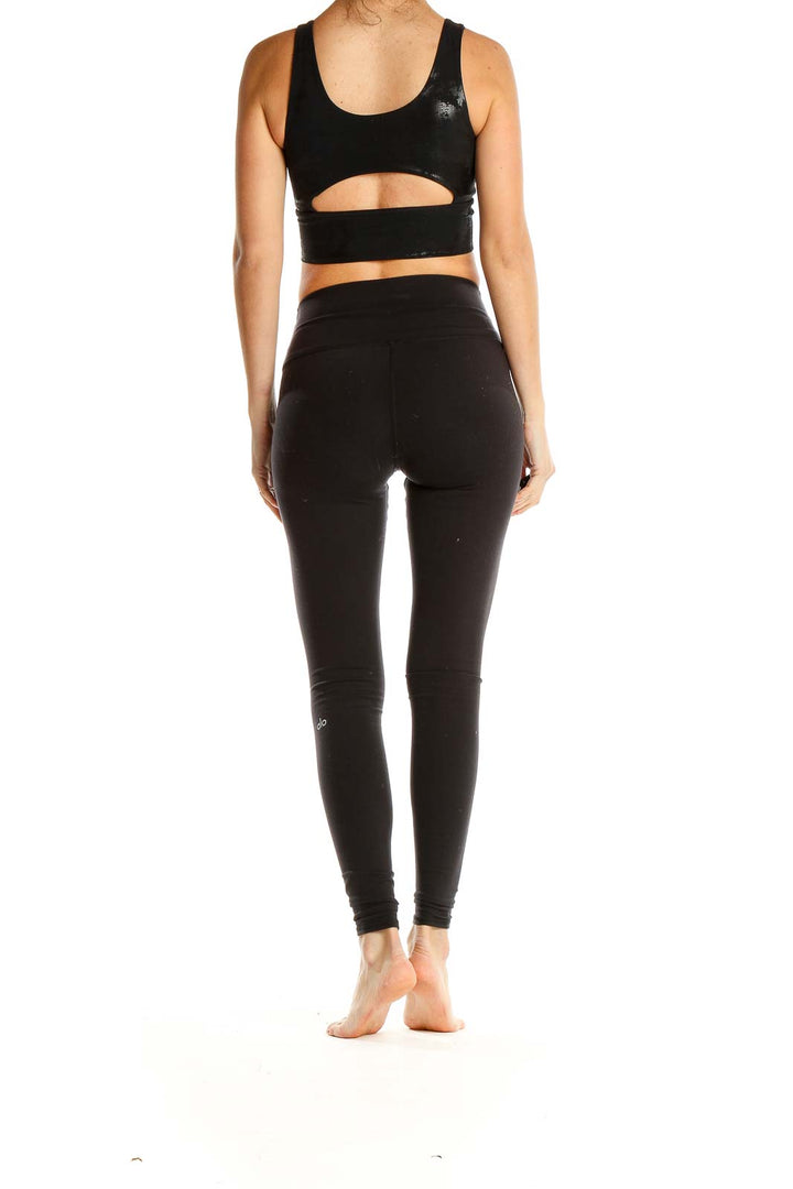 Side view of black DYI athletic crop top and matching leggings