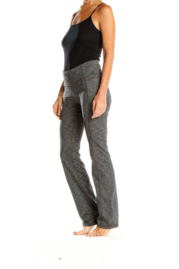 Front view of Athleta gray heathered yoga pants on model