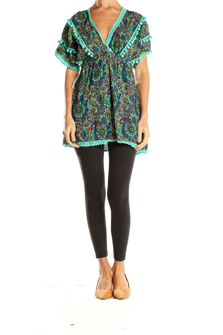 Front view of teal paisley tunic top with pom-pom trim