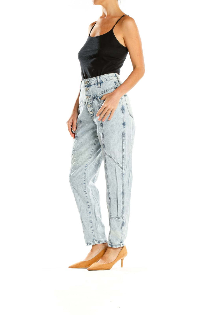 Front view of Free People light blue acid wash high-waisted jeans with paneled design