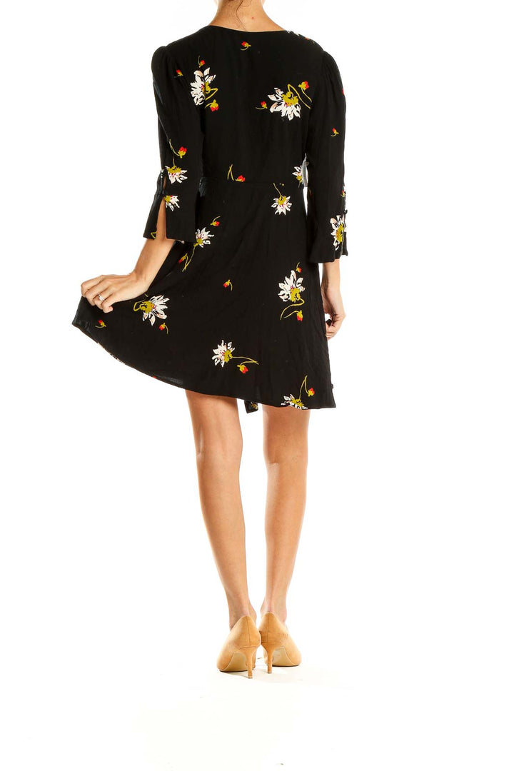 Back view of Free People black floral mini dress showing all-over print