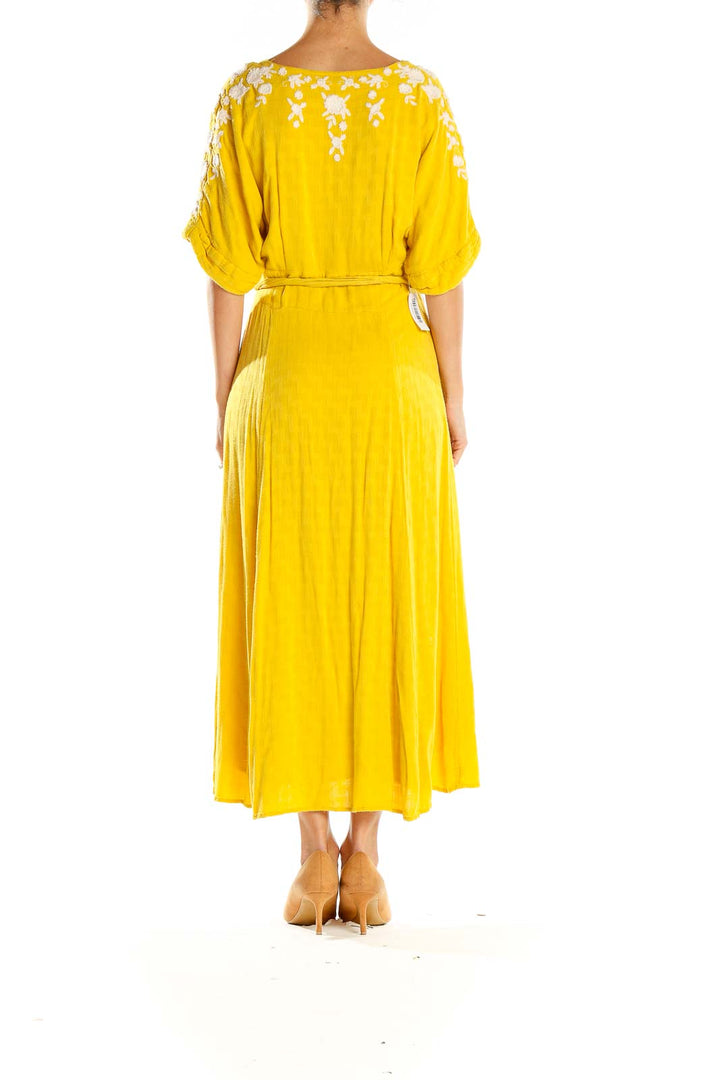 Back view of Free People yellow embroidered maxi dress showing floral embroidery detail