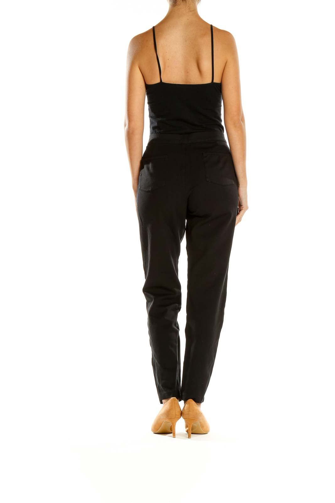 Side view of Tart black pants showing tapered leg and high waist