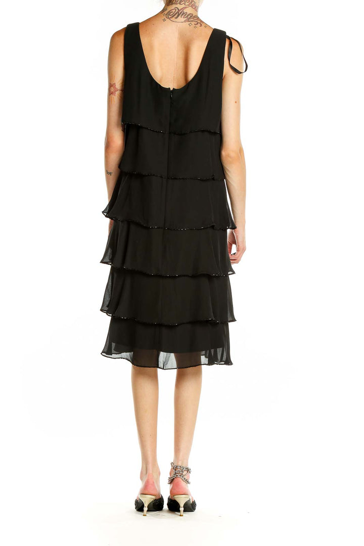 Back view of Patra black tiered chiffon cocktail dress showing layered design