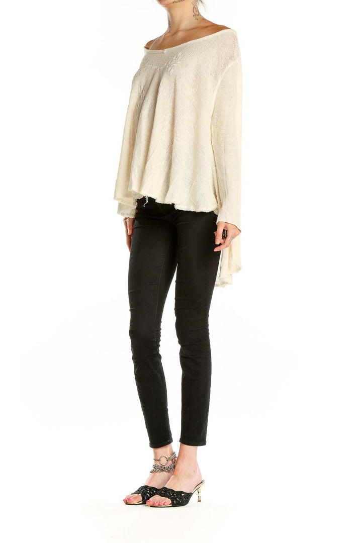 Front view of cream off-shoulder flowy knit top by Free People