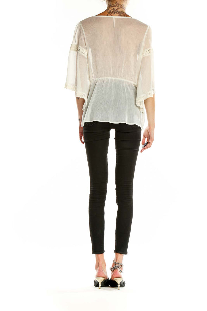 Back view of white sheer lace-trimmed boho blouse from Free People