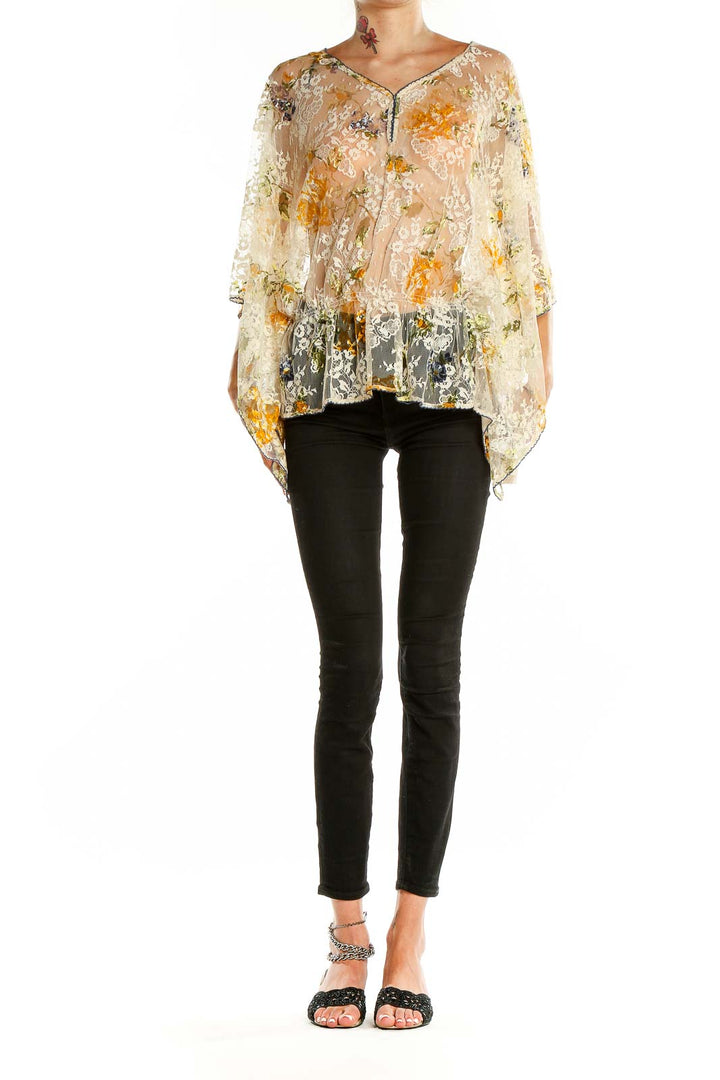 Front view of Free People beige floral lace sheer poncho top