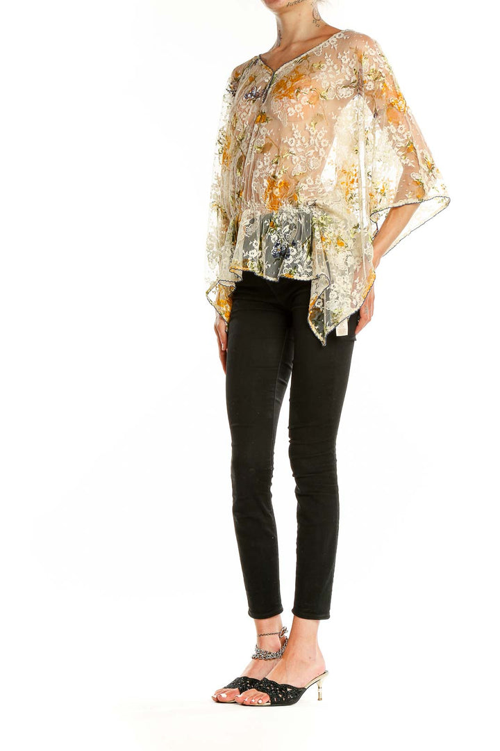 Front view of Free People beige floral lace sheer poncho top