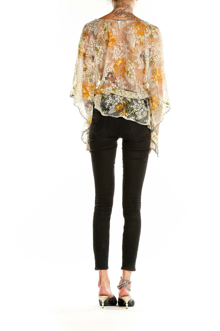 Back view of Free People beige floral lace sheer poncho top