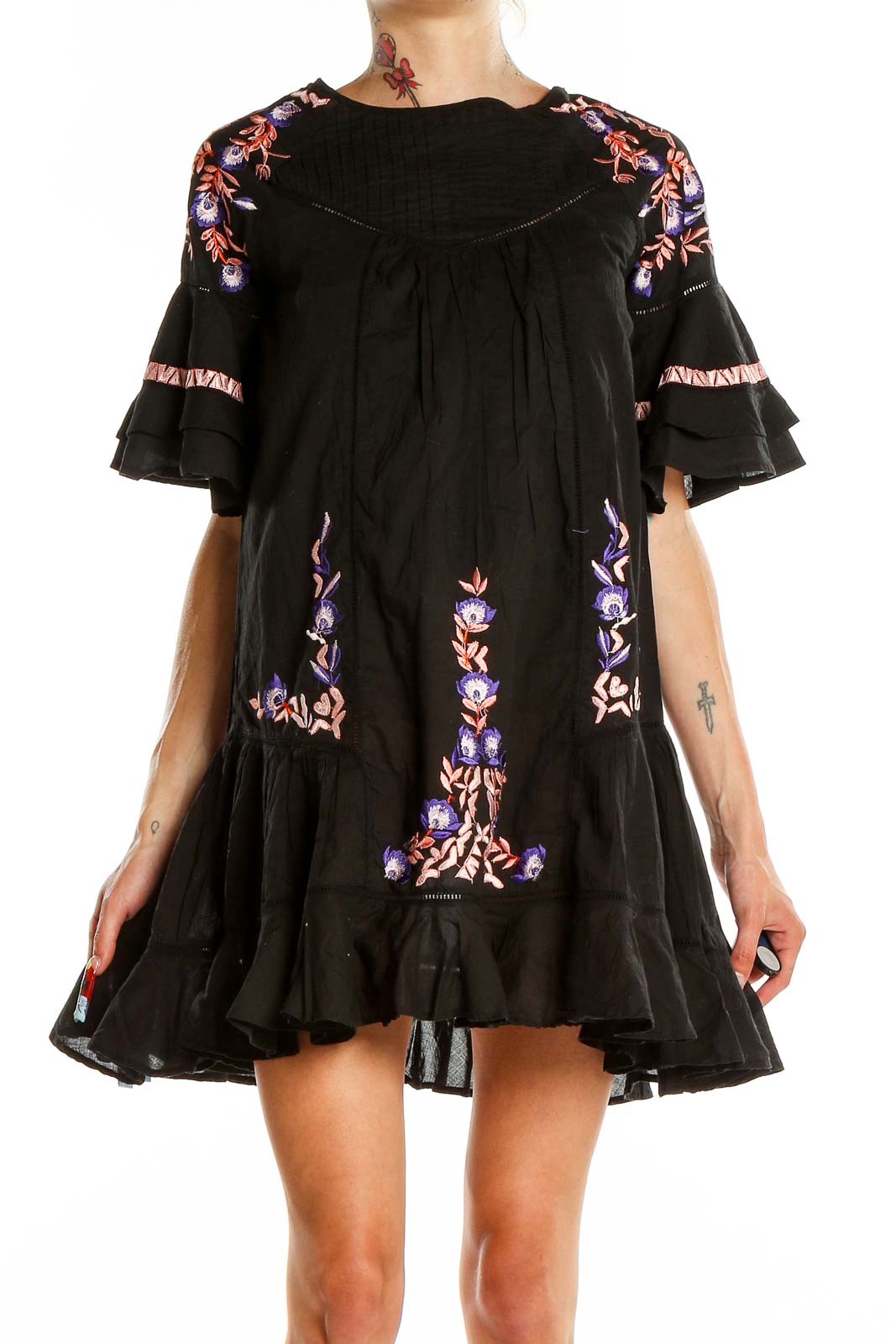 Front view of Free People black mini dress with colorful floral embroidery and ruffle details