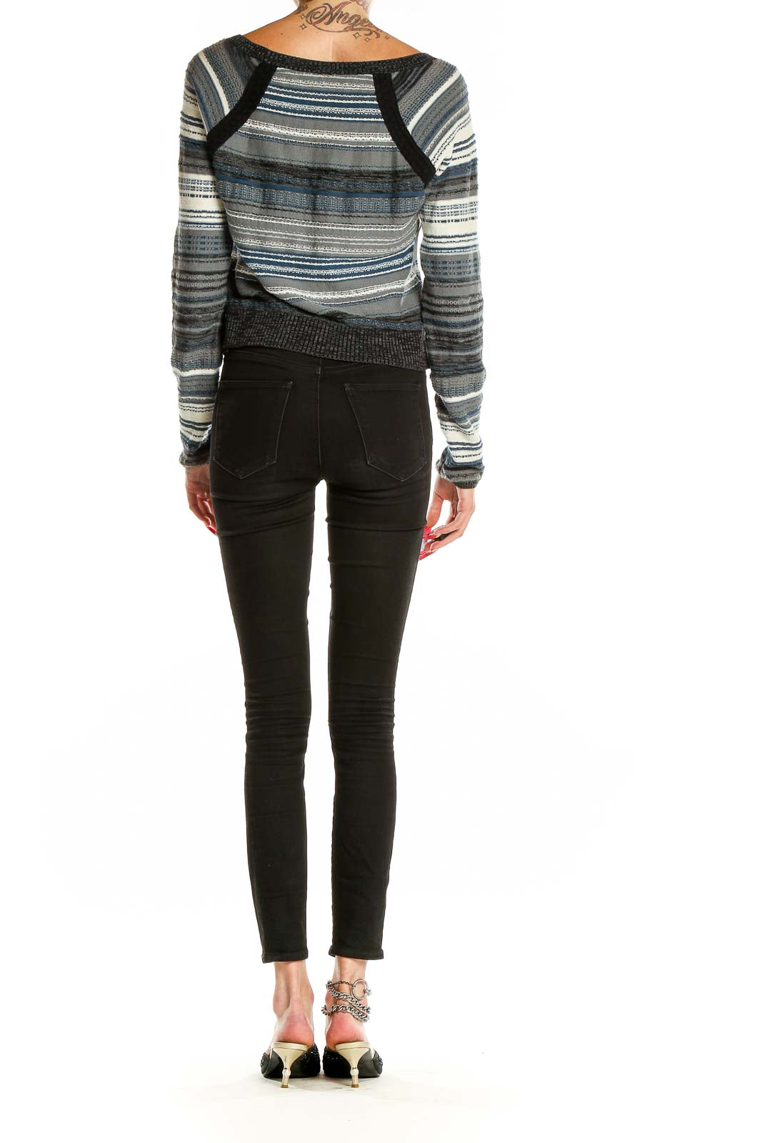 Back view of Free People Blue Striped Cropped Knit Sweater on model with black jeans