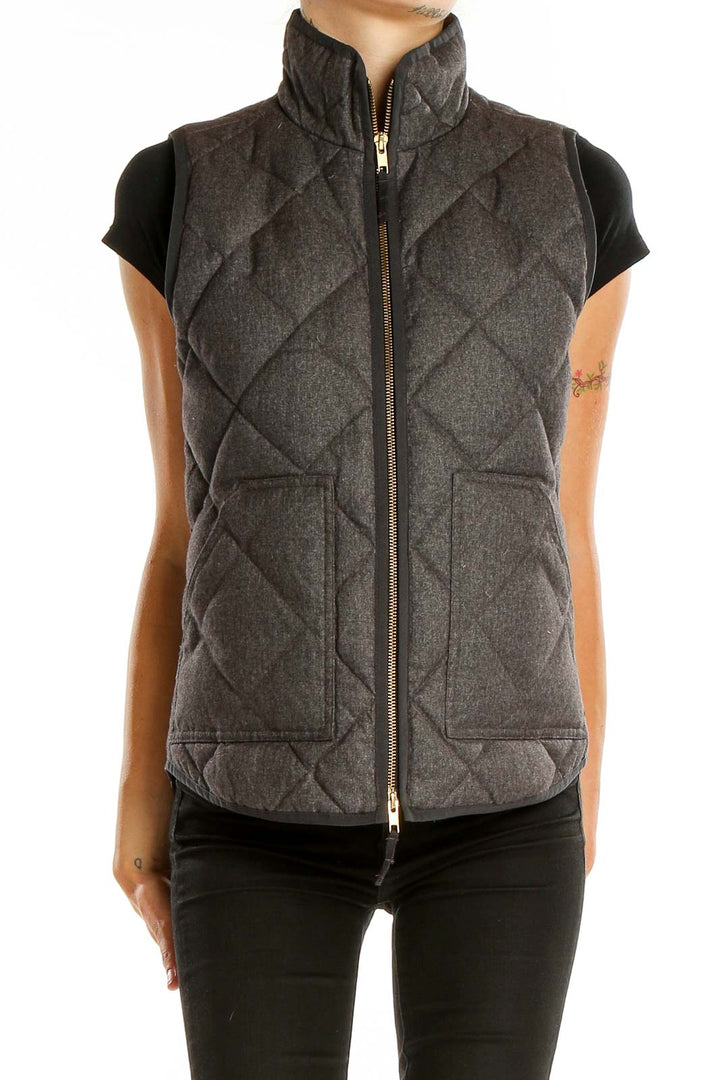 Front view of J.Crew charcoal quilted puffer vest with high collar and zipper closure