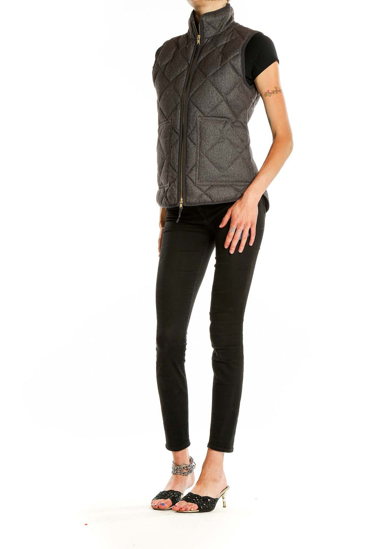 Front view of J.Crew charcoal quilted puffer vest with high collar and zipper closure