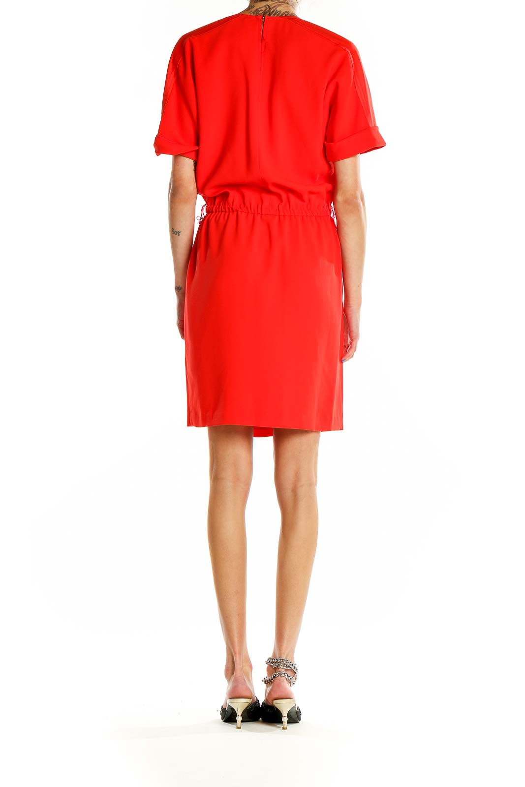 Back view of red Trina Turk wrap-style dress showing cinched waist and knee-length hem