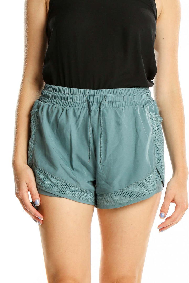 Front view of teal SilkRoll athletic shorts with mesh details