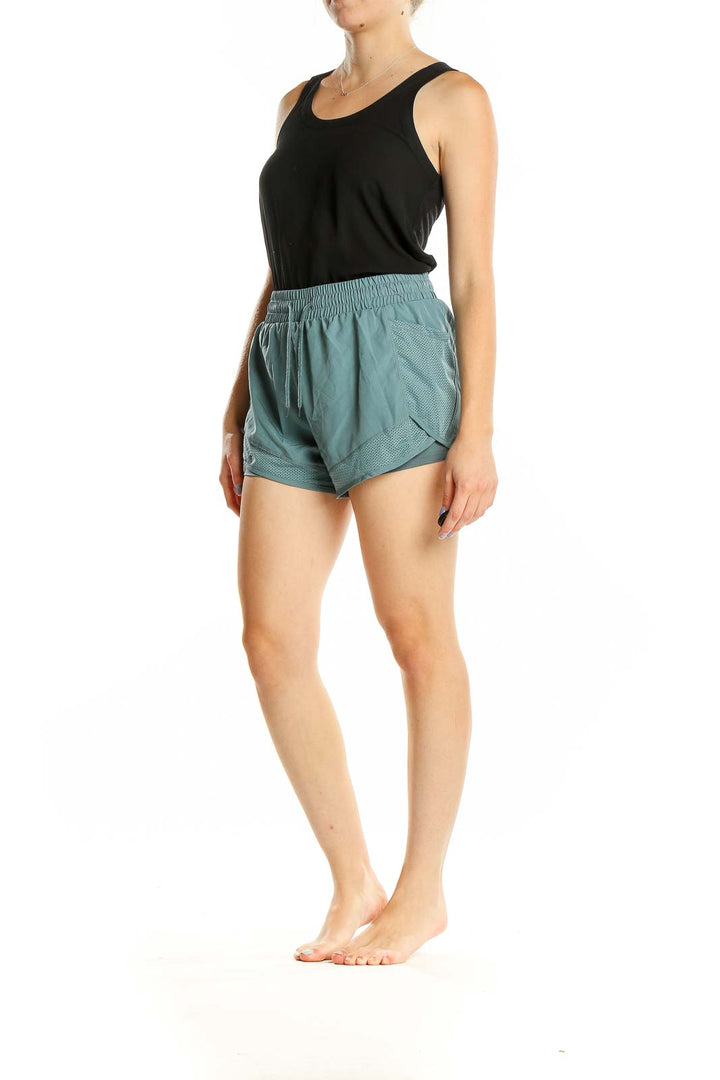 Front view of teal SilkRoll athletic shorts with mesh details