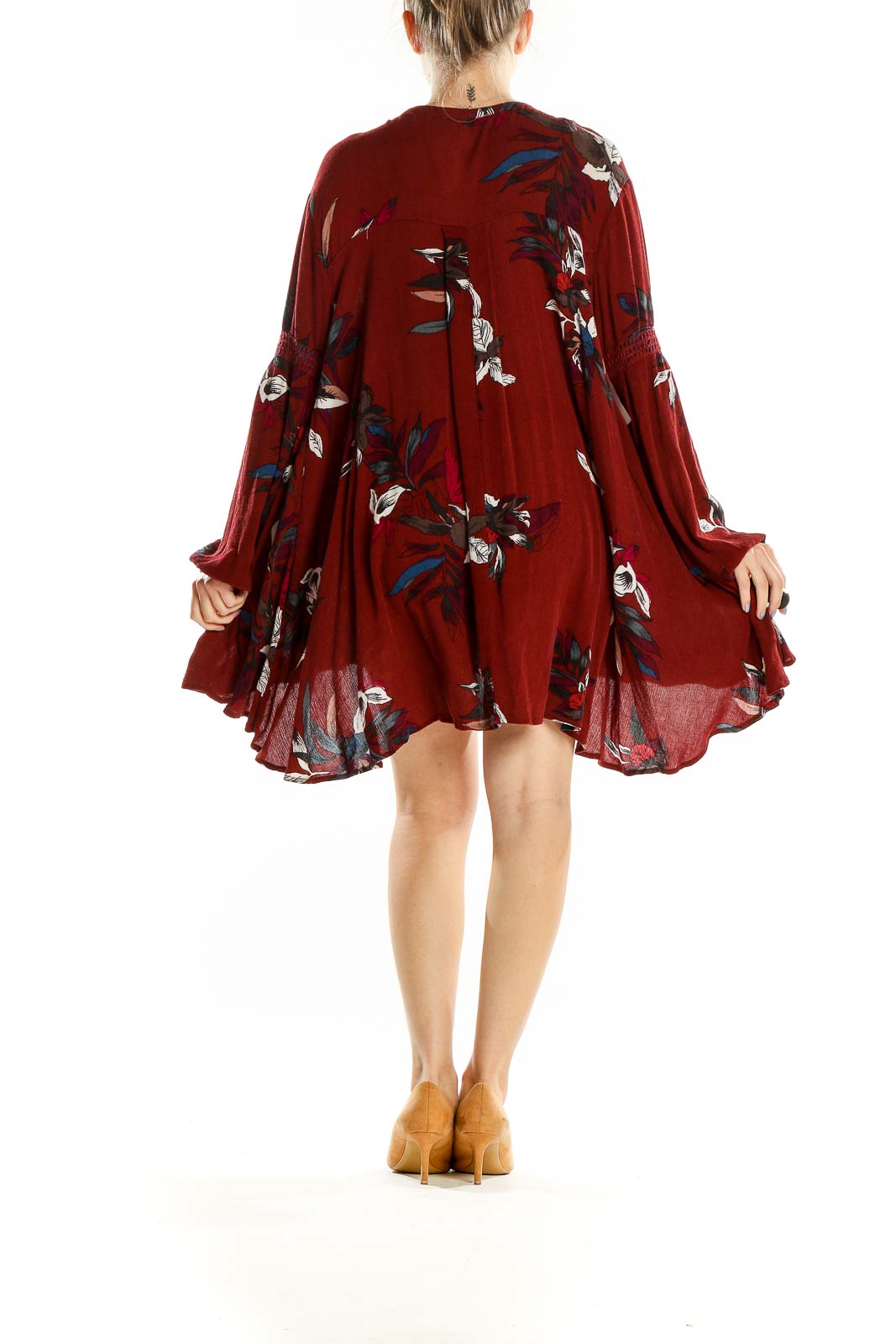 Back view of burgundy floral long sleeve mini dress showing flowy silhouette