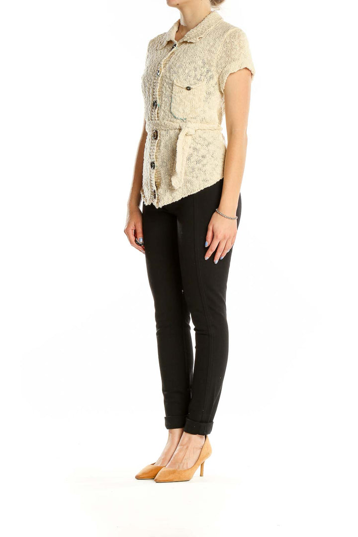 Front view of cream knit short-sleeve button-up cardigan from Free People