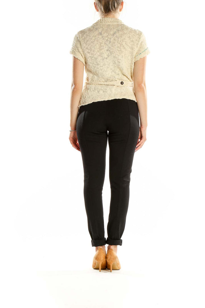 Back view of cream knit short-sleeve button-up cardigan from Free People with waist tie