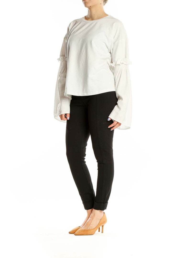 Front view of white Gilli top with bell sleeves and ruffle details