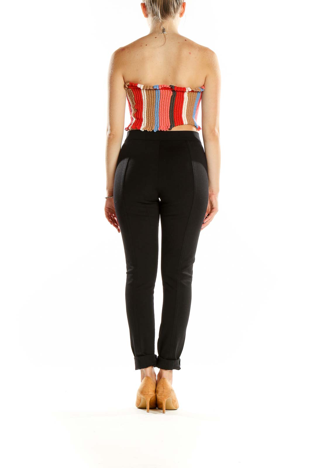 Back view of Urban Outfitters multicolor striped knit crop top with black pants