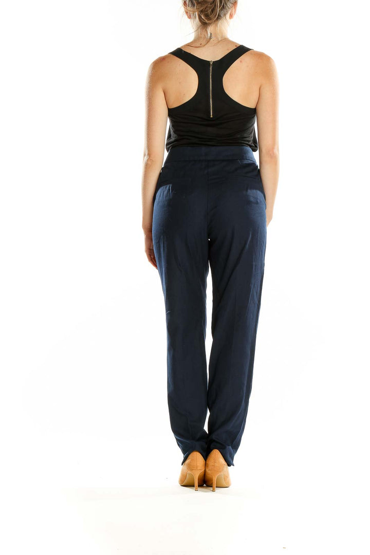 Side view of Trina Turk navy tailored straight-leg trousers on model