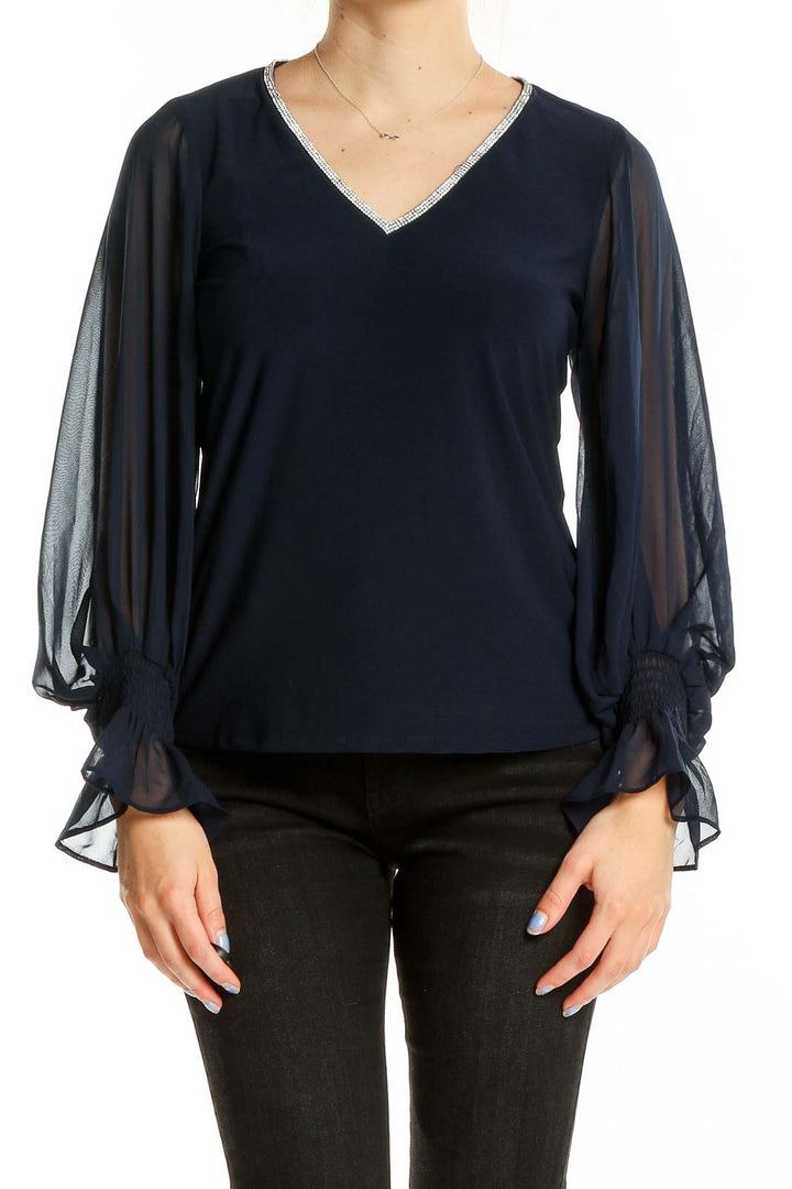 Front view of Vince Camuto navy top with sheer sleeves and V-neckline