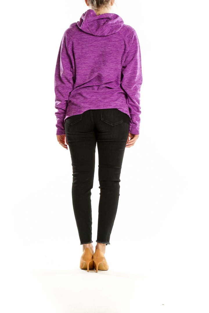 Side view of woman wearing purple Lukka activewear hoodie with black pants