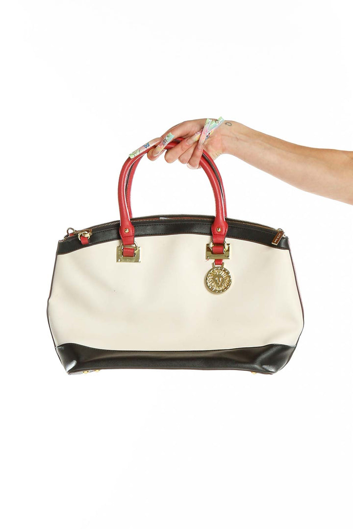 Front view of Anne Klein white and black color-block satchel with red handles