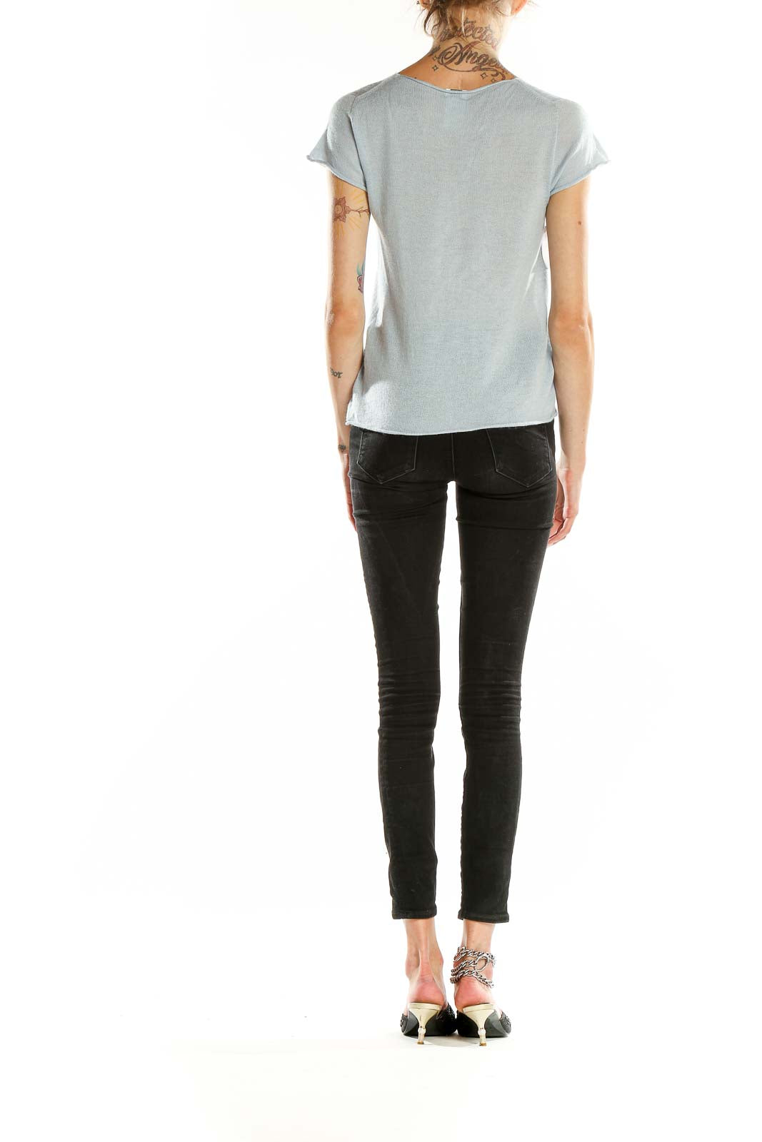 Back view of Armani Collezioni light blue short sleeve knit top with black jeans