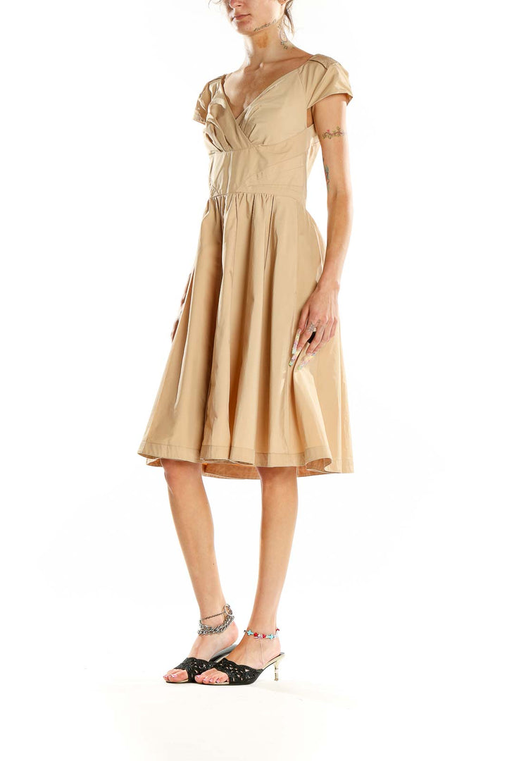 Front view of beige Pink Tartan V-neck cocktail dress with gathered waist