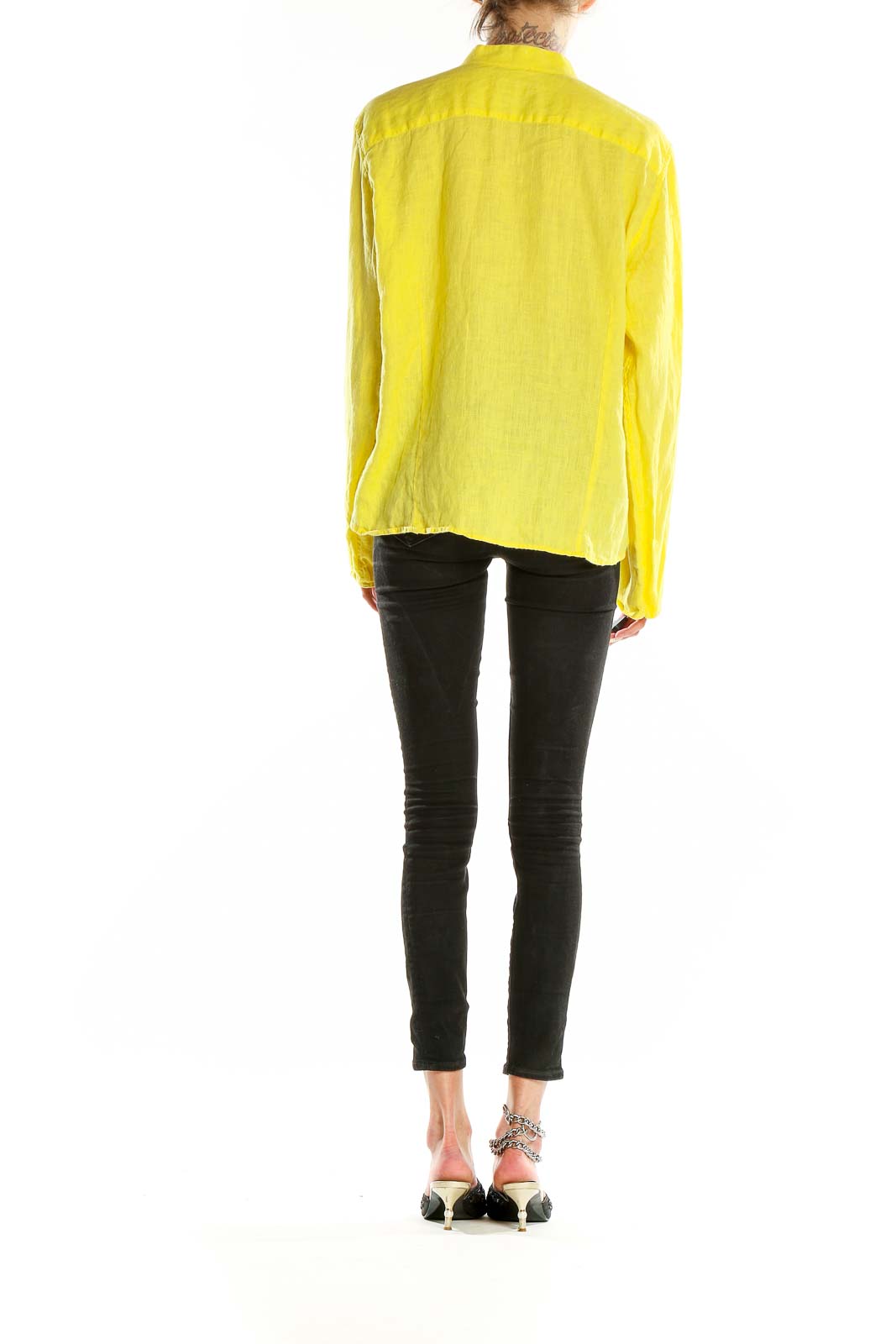 Back view of yellow linen shirt showing relaxed fit and long sleeves