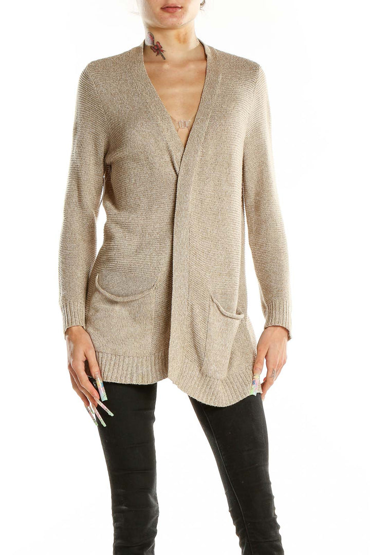 Front view of beige open-front cardigan with pockets