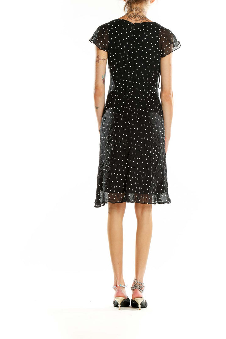 Back view of Evan Picone black polka dot dress showing A-line silhouette