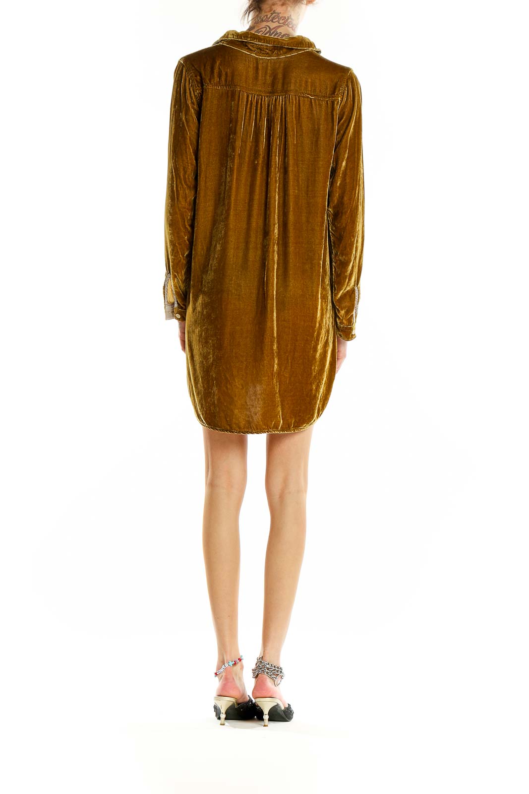 Back view of golden velvet shirt dress showing relaxed fit and high-low hemline