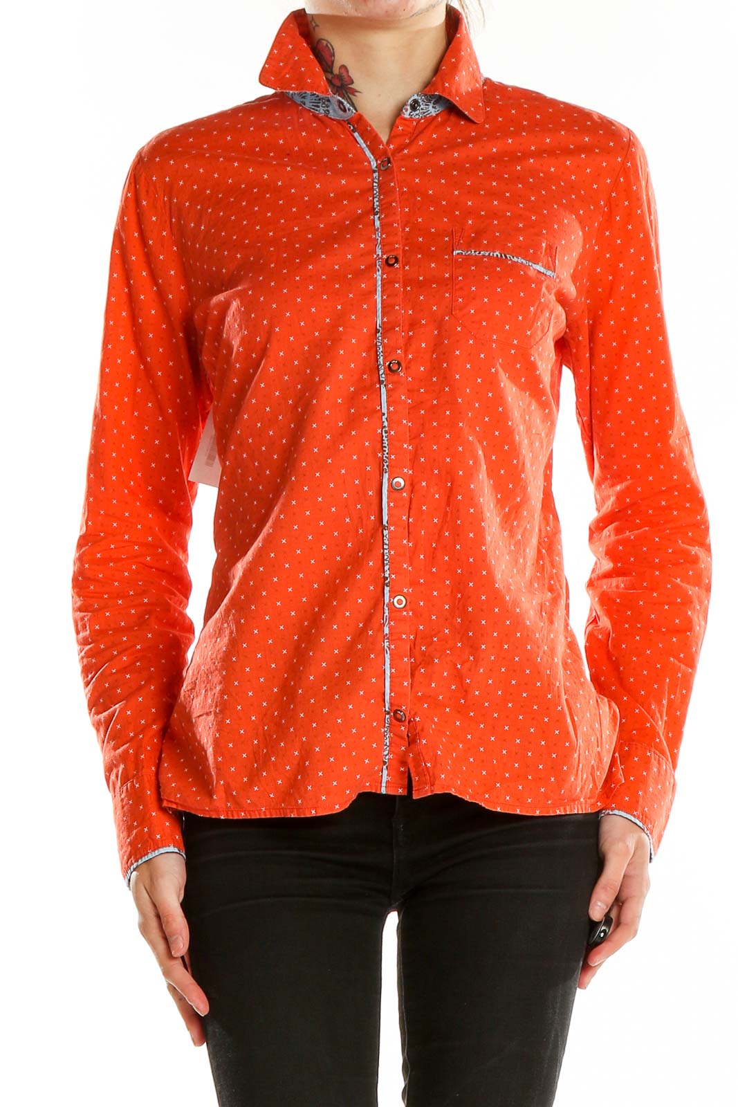 Front view of LOLE orange polka dot button-up shirt with long sleeves