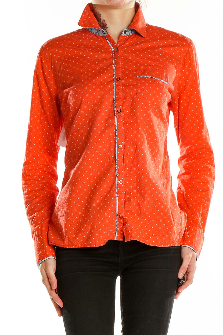 Front view of LOLE orange polka dot button-up shirt with long sleeves