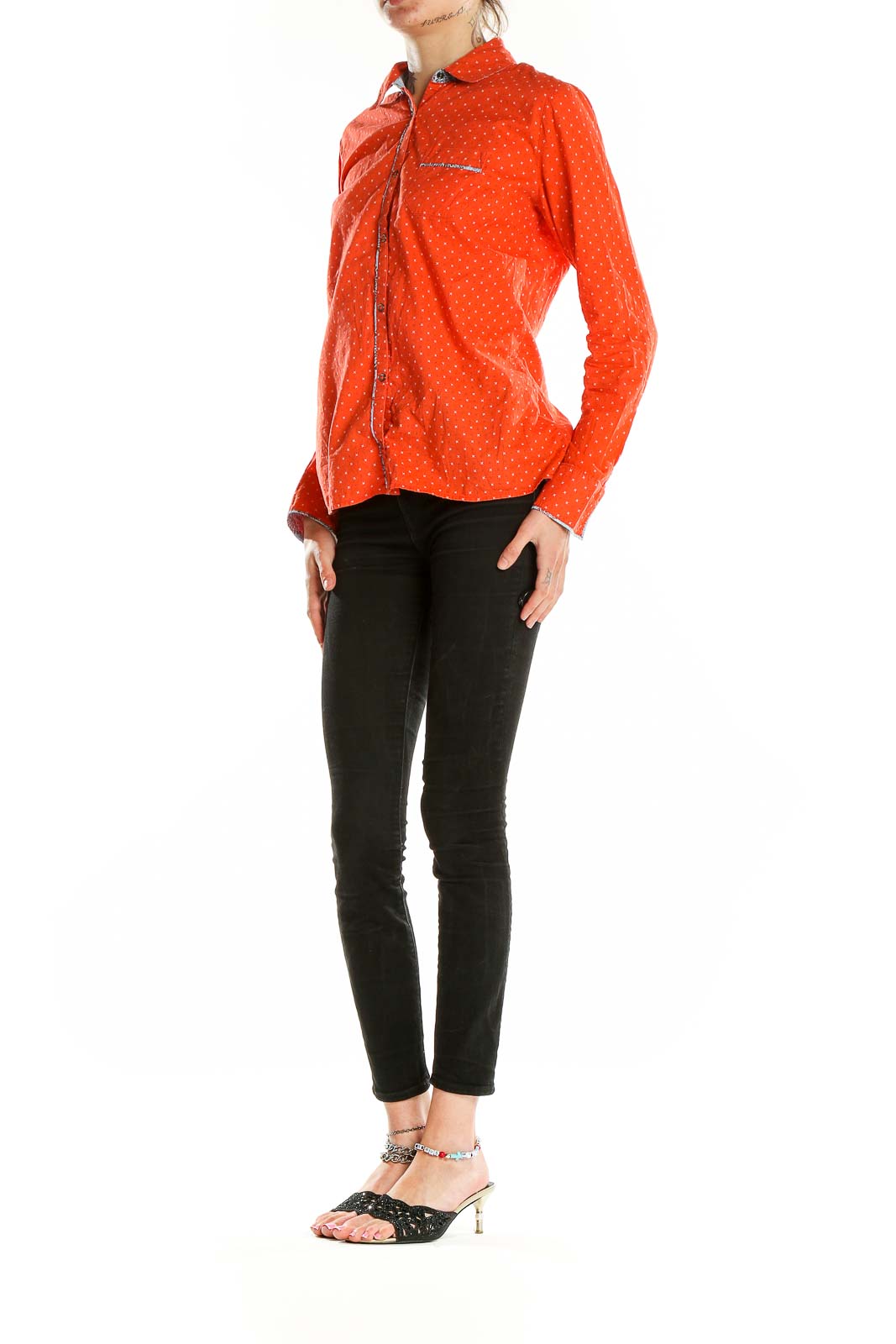 Front view of LOLE orange polka dot button-up shirt with long sleeves