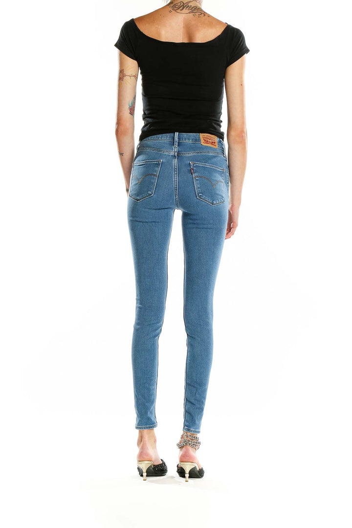 Back view of Levi's light blue high-waisted skinny jeans on model