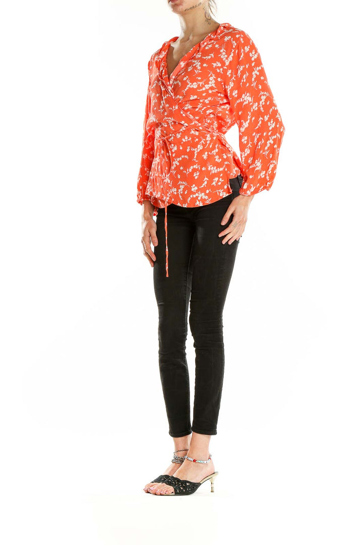 Front view of Gap orange floral wrap blouse with V-neck and waist tie