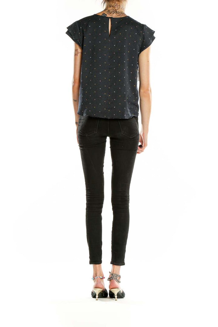 Back view of Ann Taylor black polka dot blouse showing keyhole closure