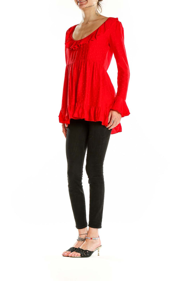 Front view of red ruffled long sleeve babydoll top by For Love & Lemons